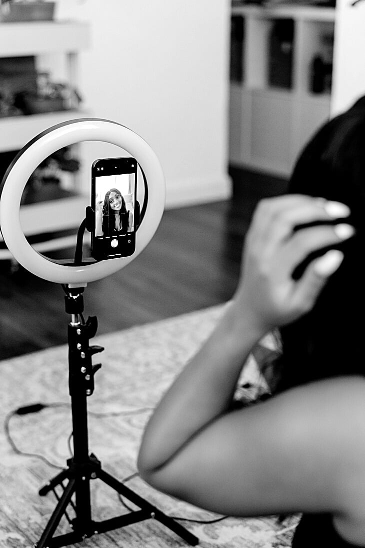 Woman Recording Herself on Smartphone with Ring Light